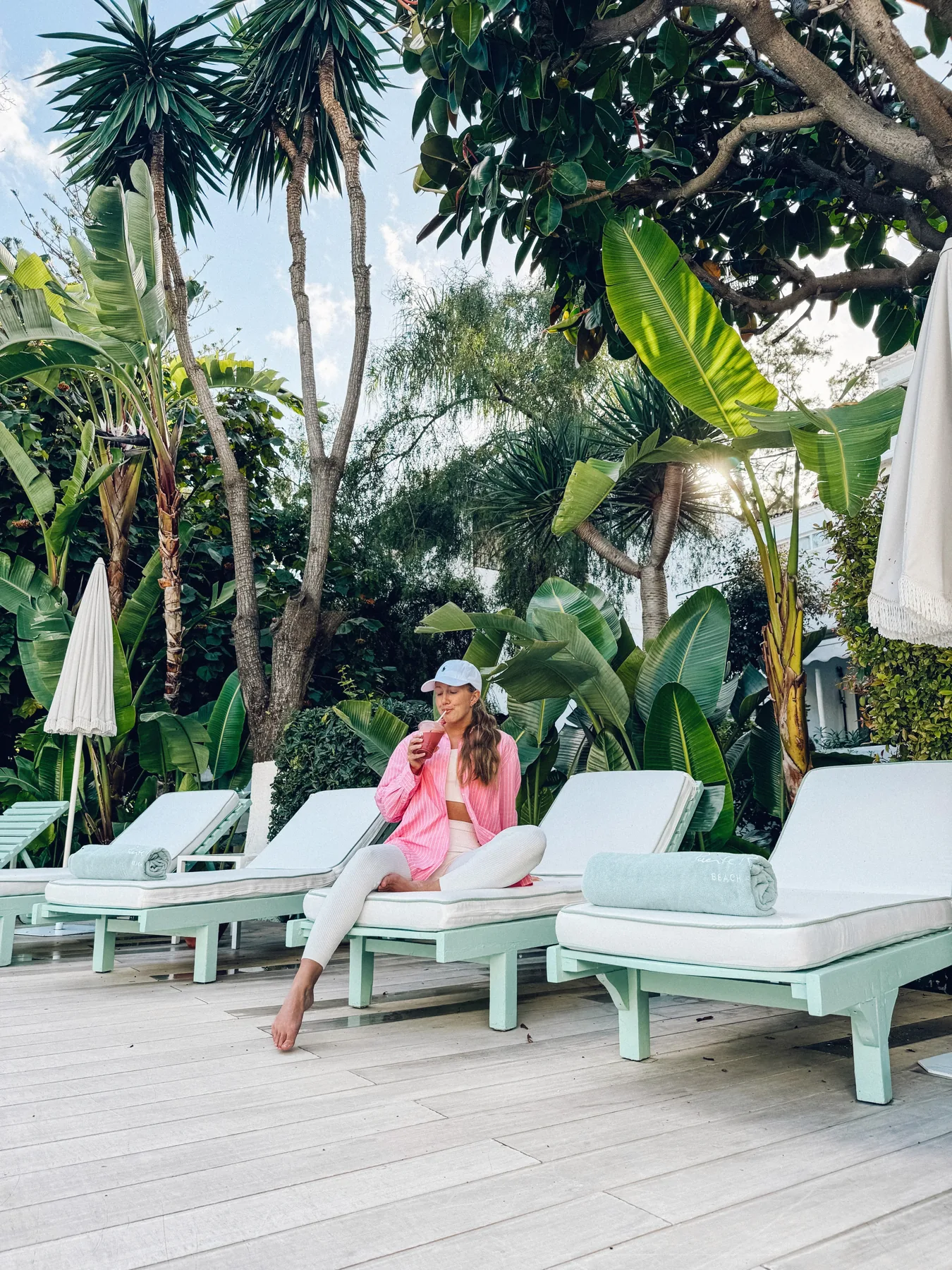 Marie Wasserman with a smoothie among palm trees